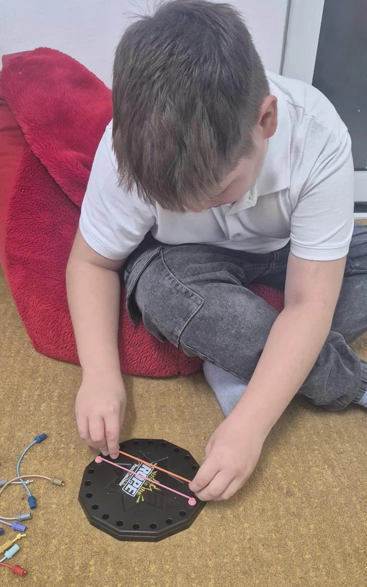 Alex doing fine motor activities